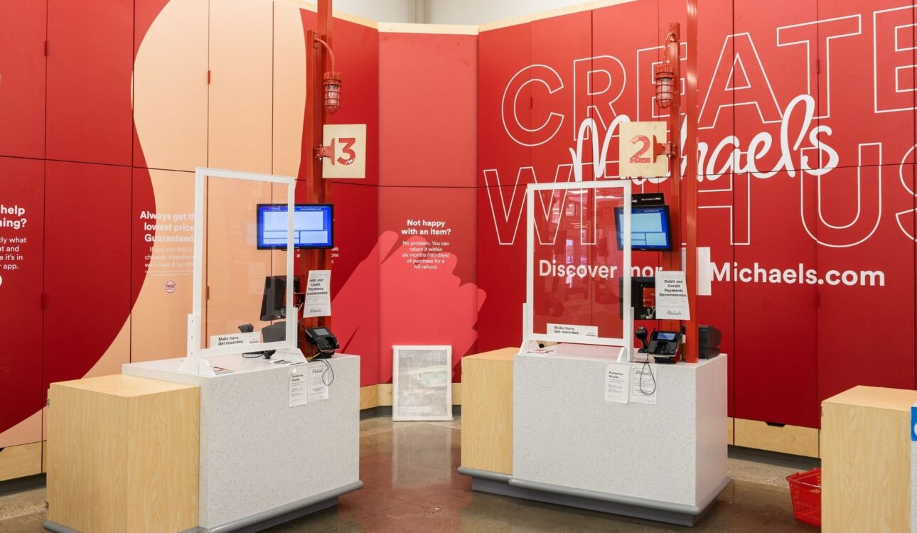 Michaels registers with branded wall behind - Accel Group Portfolio Project