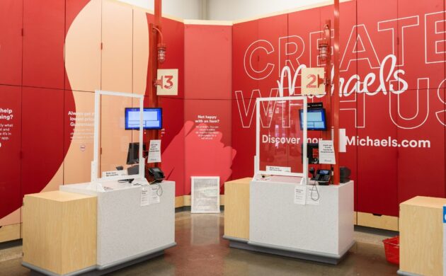 Michaels registers with branded wall behind - Accel Group Portfolio Project